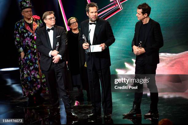 German directors Achim von Borries , Henk Handloegten and Tom Tykwer receive their European Achievement in Fiction Awards onstage during the 32nd...