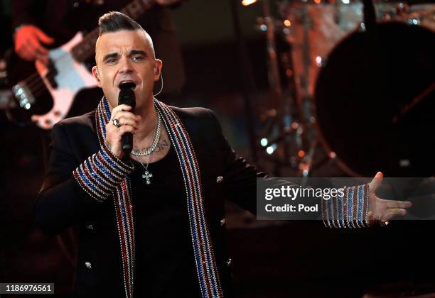 British singer Robbie Williams performs onstage during the Ein Herz Fuer Kinder Gala show at Studio Berlin Adlershof on December 7, 2019 in Berlin,...