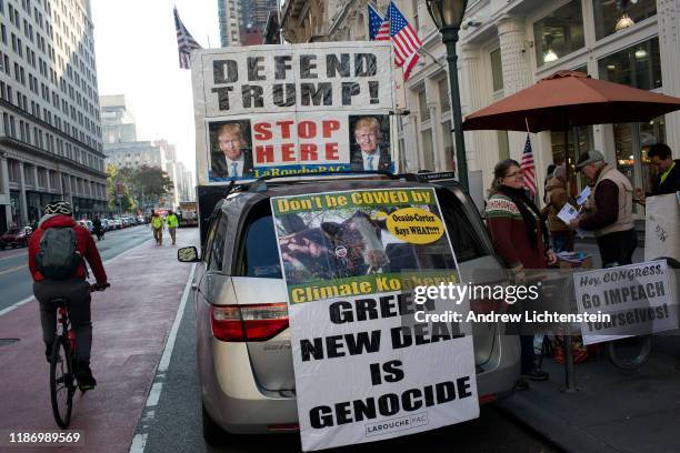 Lyndon Larouche supporters solicit support for President Trump while he attends New York Veterans Day Parade on November 11, 2019 in New York City.