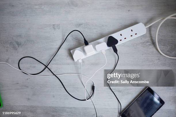 digital devices plugged in to a extension lead - electrical plug stock pictures, royalty-free photos & images