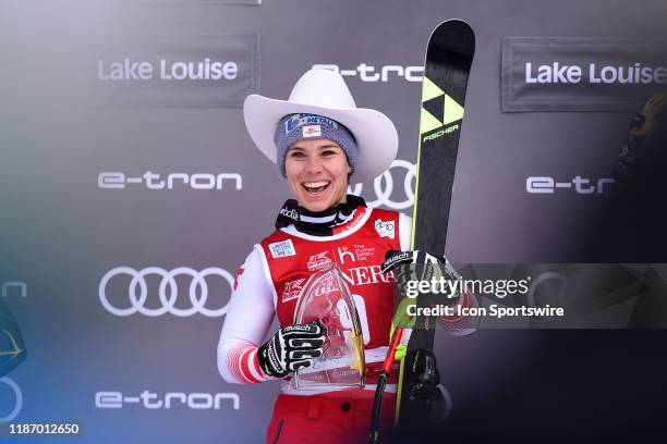 Nicole Schmidhofer of Austria smiles on the podium after winning the downhill event at the Lake Louise Audi FIS Ski World Cup on December 7 at the...