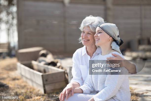 farmor och barnbarn wit cancer sitter på en bänk lager foto - cancerland 2019 bildbanksfoton och bilder
