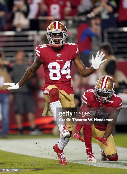 Wide receiver Kendrick Bourne of the San Francisco 49ers celebrates his touchdown with teammate Emmanuel Sanders in the first quarter over the...