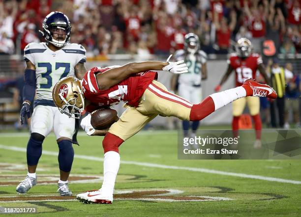 Wide receiver Kendrick Bourne of the San Francisco 49ers scores a touchdown the first quarter over the defense of defensive back Quandre Diggs of the...