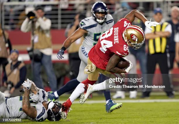 Wide receiver Kendrick Bourne of the San Francisco 49ers scores a touchdown the first quarter over the defense of the Seattle Seahawks at Levi's...