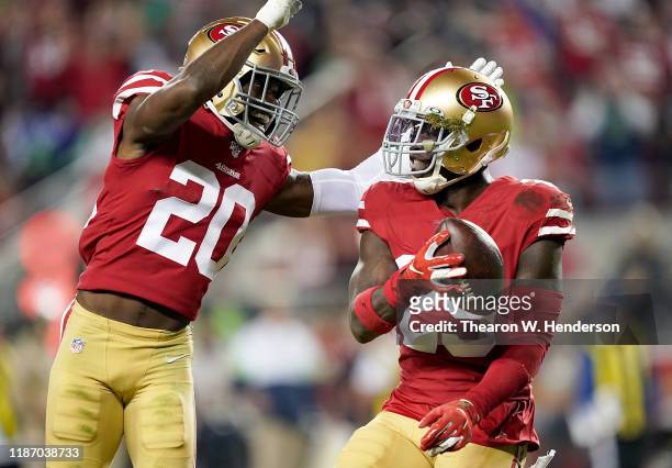 Strong safety Jaquiski Tartt and free safety Jimmie Ward of the San Francisco 49ers celebrate Tartt stripping the ball from wide receiver D.K....