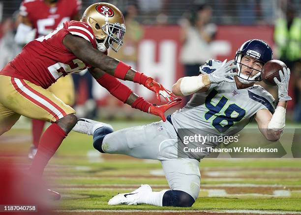 Tight end Jacob Hollister of the Seattle Seahawks catches a pass for a touchdown over strong safety Jaquiski Tartt of the San Francisco 49ers in the...