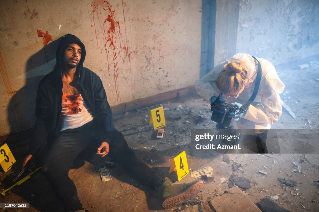 Forensic Scientist Photographing Evidence at Crime Scene