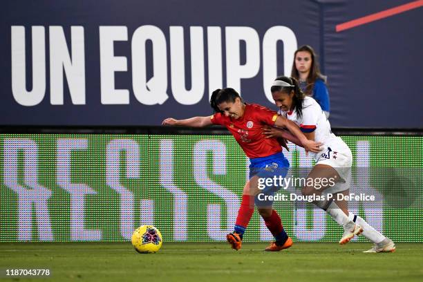 Margaret Purce of the U.S. Woman's national soccer team and Lixy Rodriguez of the Costa Rica woman's national soccer team fight for the ball during...