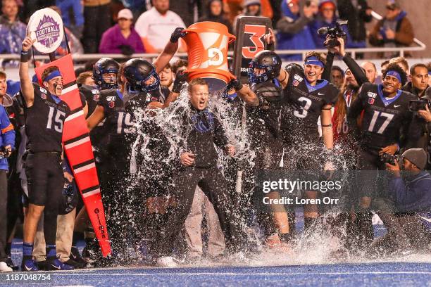 Head Coach Brian Harsin of the Boise State Broncos is doused in gatorade during second half action in the Mountain West Championship against the...