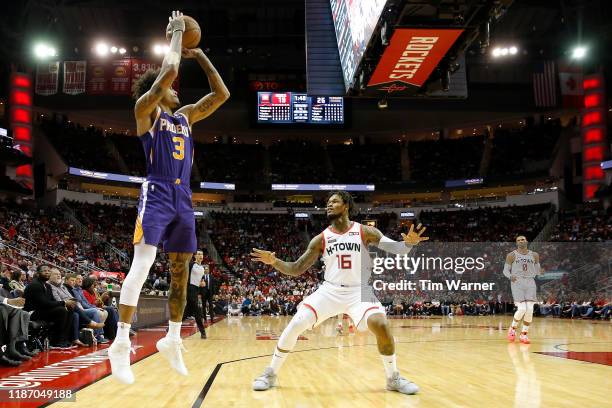 Kelly Oubre Jr. #3 of the Phoenix Suns takes a three point shot defended by Ben McLemore of the Houston Rockets in the first half at Toyota Center on...