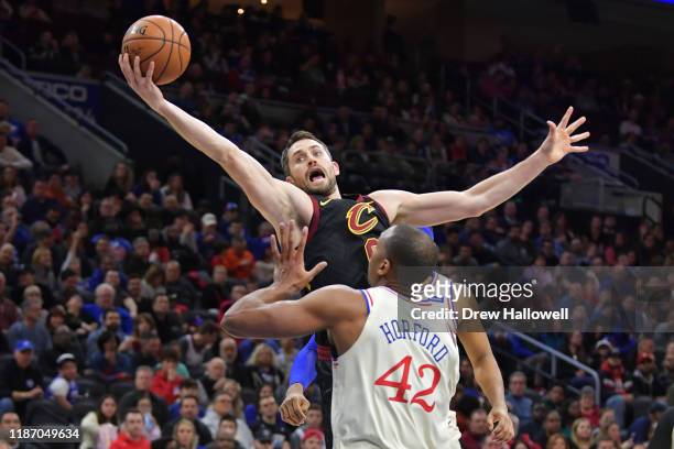 Kevin Love of the Cleveland Cavaliers grabs a rebound above Al Horford of the Philadelphia 76ers in the first half at Wells Fargo Center on December...