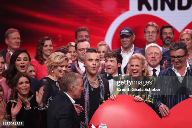 Julia Kloeckner, Johannes B. Kerner, Robbie Williams, Barbara Schoeneberger, Boris Becker, Hans Sigl with the final donation check during the Ein...