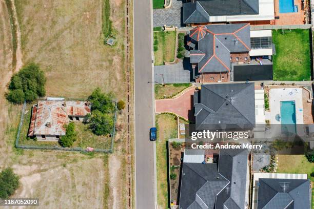 old abandoned farmhouse and new houses, suburb on edge of city, urban sprawl in sydney, australia, aerial photography - farmhouse stock pictures, royalty-free photos & images