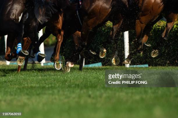 Jockeys ride their horses at the Hong Kong Cup during the Hong Kong International Races at the Sha Tin Racecourse on December 8, 2019.