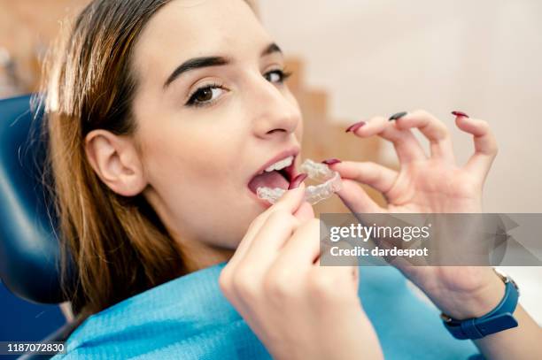 wearing orthodontic silicone trainer - invisible braces stock pictures, royalty-free photos & images