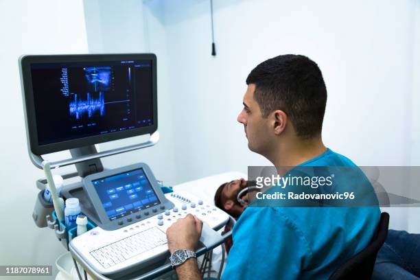 checking thyroid gland by ultrasound - throat stock pictures, royalty-free photos & images
