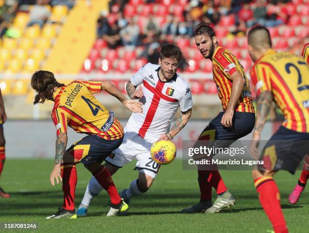 Jacopo Petriccione of Lecce competes for the ball with Lasse Schone of Genoa during the Serie A match between US Lecce and Genoa CFC at Stadio Via...