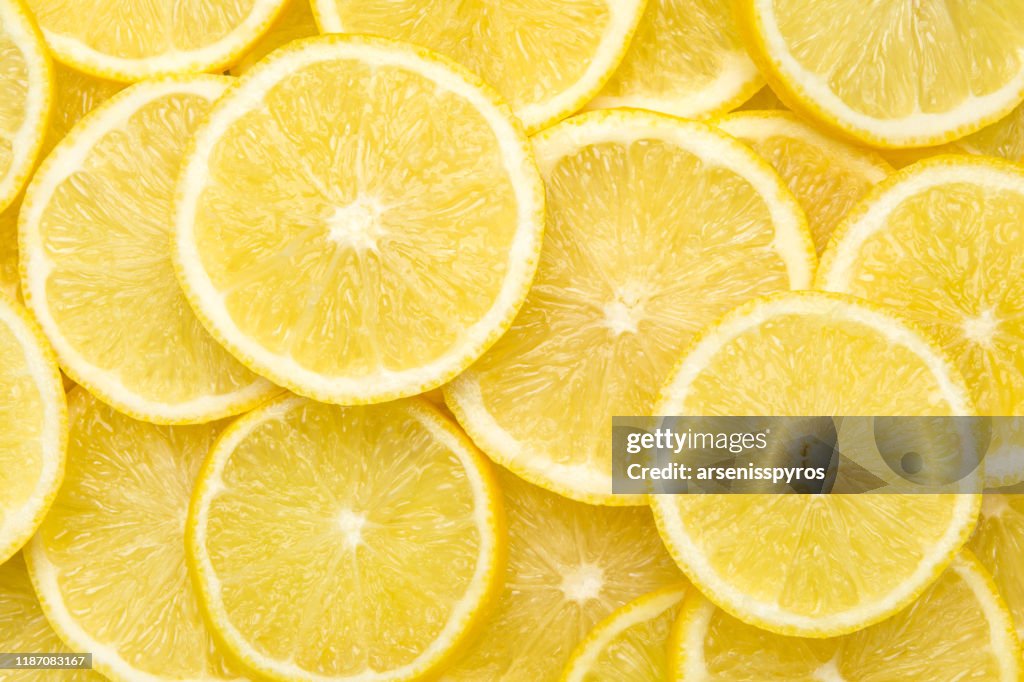 Fresh lemon slices pattern background, close up