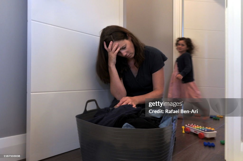 Mother tired to tidy up the house