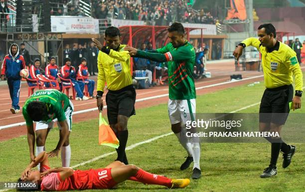 Indian referee Rahul Kumar Gupta gives a red card to Bangladesh captain and midfielder Jamal Bhuyan during the football match between Nepal and...
