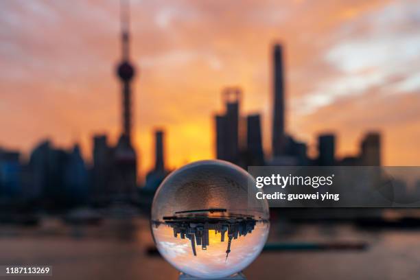 sunrise from the crystal ball to see the shanghai skyline - crystal ball stock-fotos und bilder
