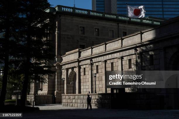 Japan's national flag flies atop the Bank of Japan building on November 12, 2019 in Tokyo, Japan.