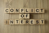 conflict of interest text from wooden blocks
