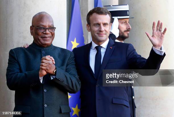 French President Emmanuel Macron welcomes Mali's President Ibrahim Boubacar Keita prior a lunch at the Elysee Presidential Palace on November 12,...
