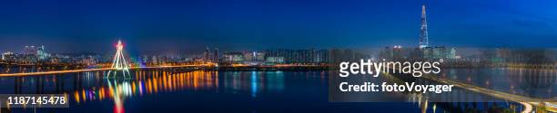 futuristic highrise cityscape panorama illuminated waterfront at night seoul korea - lotte world tower stock pictures, royalty-free photos & images