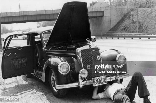 Actor George Peppard fixes car that has broken down while campaigning for Presidential candidate Jimmy Carter near Philadelphia, Pennsylvania in May...