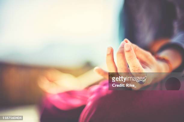 young woman practicing yoga and meditation in sunshine of india - zen stock pictures, royalty-free photos & images