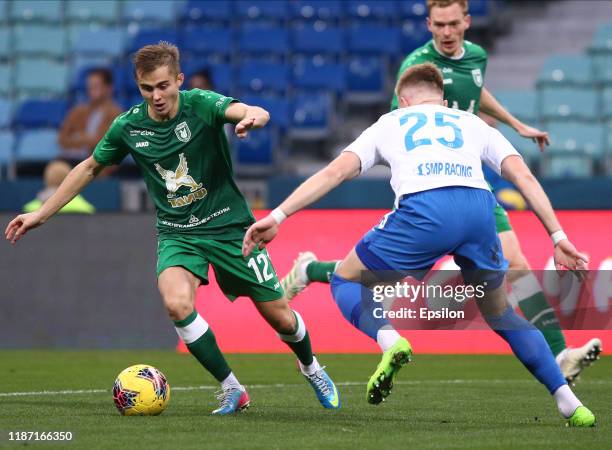 Ivan Novoseltsev of PFC Sochi vies for the ball with Aleksandr Zuyev of FC Rubin Kazan during the Russian Premier League match between PFC Sochi v FC...