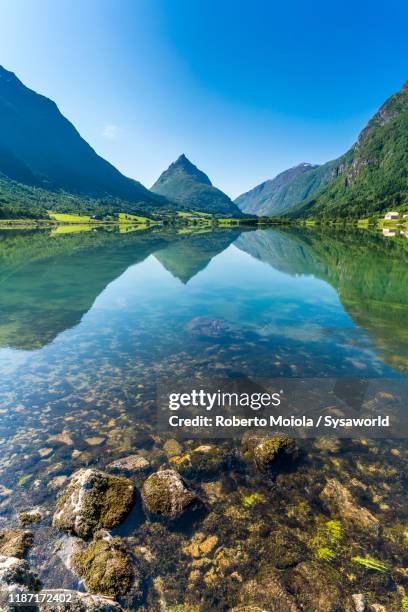 mountains reflected in nordfjord, sogn og fjordane, norway fjords - nordfjord stock-fotos und bilder