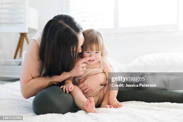 woman touching her daughter's nose - girl hold nose stock pictures, royalty-free photos & images