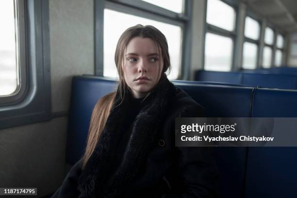 young woman wearing black fur coat on train - black coat bildbanksfoton och bilder