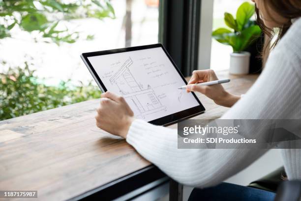 unrecognizable woman draws building cross sections on digital tablet - digitized pen stock pictures, royalty-free photos & images