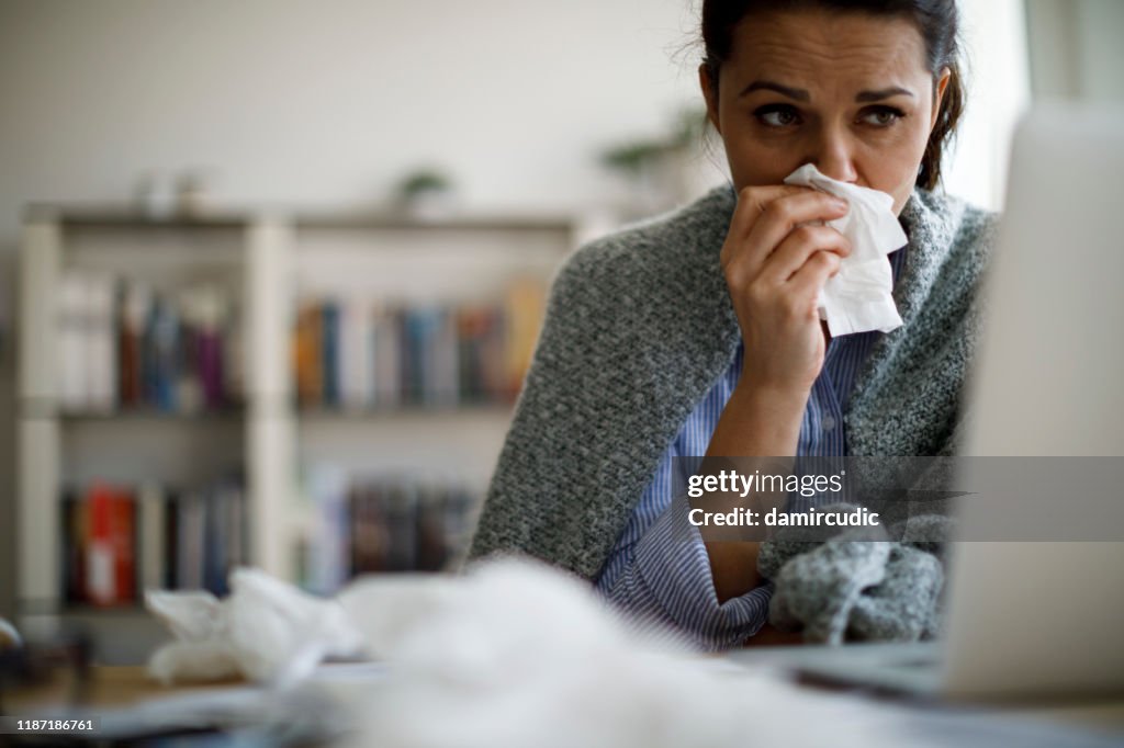 Woman blowing her nose