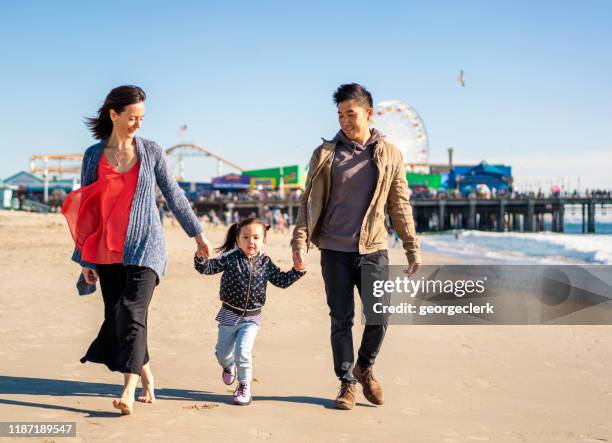 family visiting santa monica beach - beach la stock pictures, royalty-free photos & images