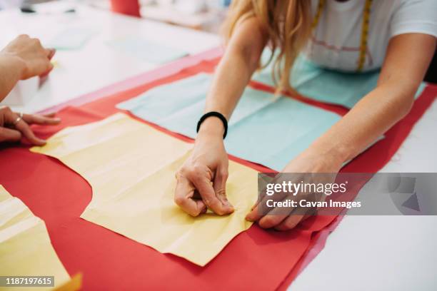 fashion designer preparing fabric to cut - sewing pattern bildbanksfoton och bilder