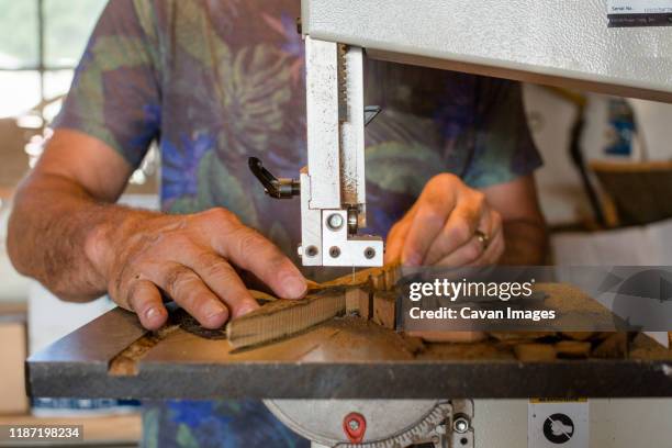 close-up view of man crafting wood art on band saw - table saw stock pictures, royalty-free photos & images