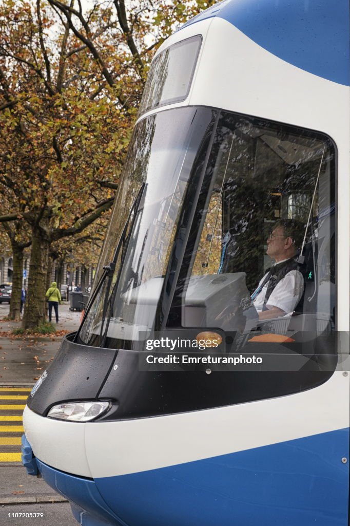 Close up of a tram with driver stopping at a pedestrian crossing in downtown Zurich,November 2019..;Zurich.