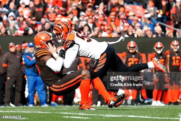 Nick Vigil of the Cincinnati Bengals forces a fumble by David Njoku of the Cleveland Browns during the first quarter at FirstEnergy Stadium on...