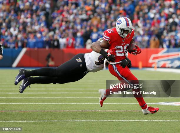 Matt Judon of the Baltimore Ravens dives to try and tackle Devin Singletary of the Buffalo Bills as he runs the ball during the first half at New Era...