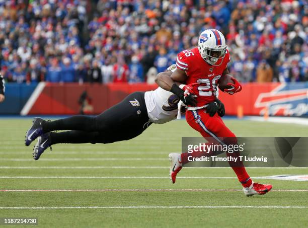 Matt Judon of the Baltimore Ravens dives to try and tackle Devin Singletary of the Buffalo Bills as he runs the ball during the first half at New Era...