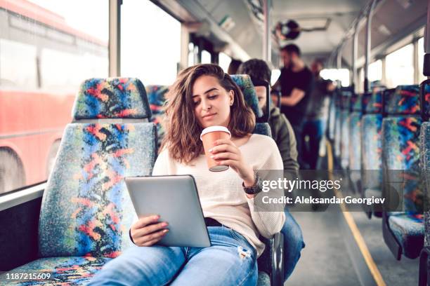 female enjoying modern technology while friends have fun in the back of bus - party bus stock pictures, royalty-free photos & images