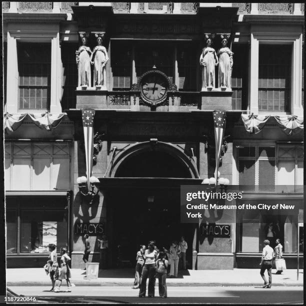 View of pedestrians outside the entrance of Macy's Herald Square with the original 34th Street facade visible, New York, New York, circa 1975.