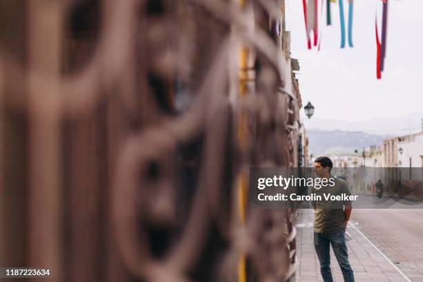 mexican man standing on a street looking out to the side - morélia imagens e fotografias de stock