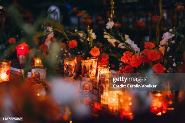 day of the dead / dia de los muertos adorned graves in the cemetery in tzintzuntzan, mexico - day of the dead stock pictures, royalty-free photos & images