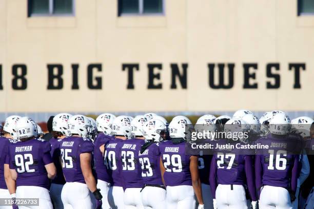 The Northwestern Wildcats huddle up during a timeout in the game against the Purdue Boilermakers at Ryan Field on November 09, 2019 in Evanston,...